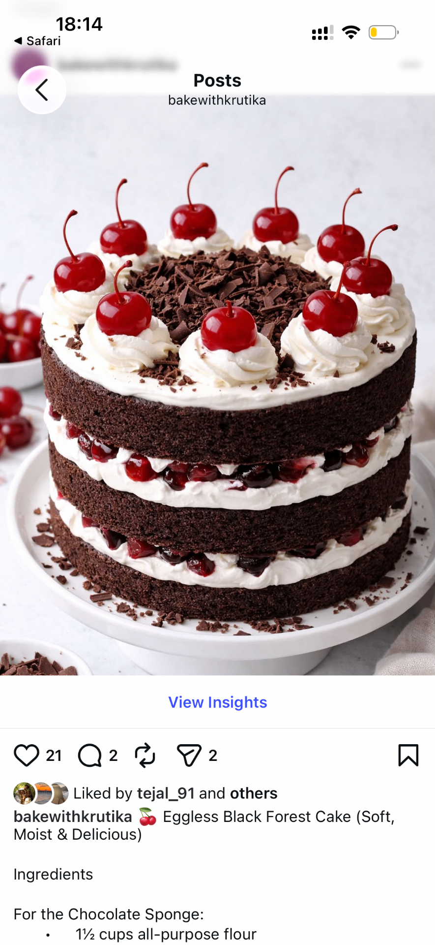 Eggless black forest cake with layers of chocolate sponge, whipped cream and cherries, topped with glacé cherries and chocolate shavings